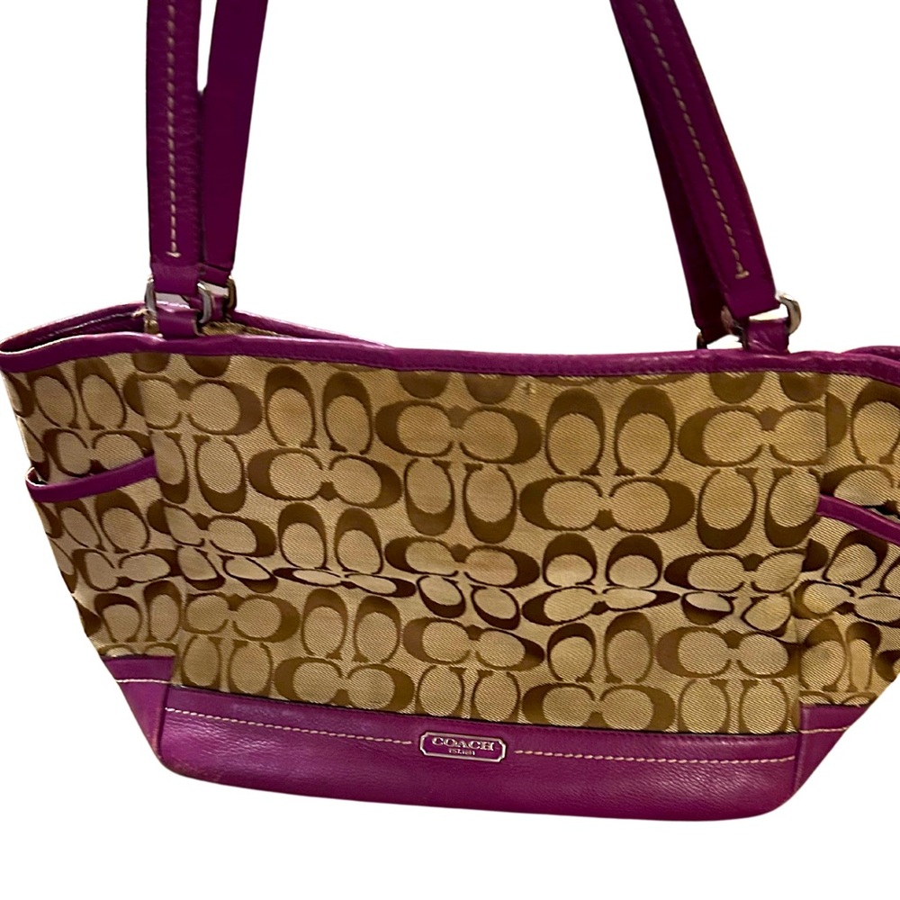 Brown and Pink Coach large bag with pockets on the outside for water bottles.